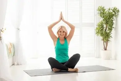 Woman practicing gentle yoga outdoors to support hormonal balance and wellness.