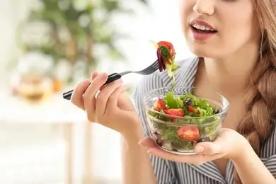 Balanced plate of hormone-supporting foods including vegetables, whole grains, and lean protein for perimenopause health.